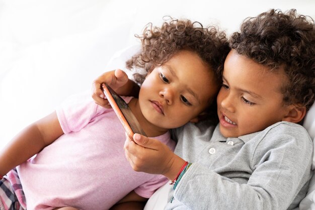 Kid playing together a game on the phone