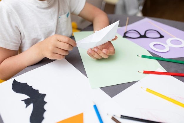 Kid playing with paper at home