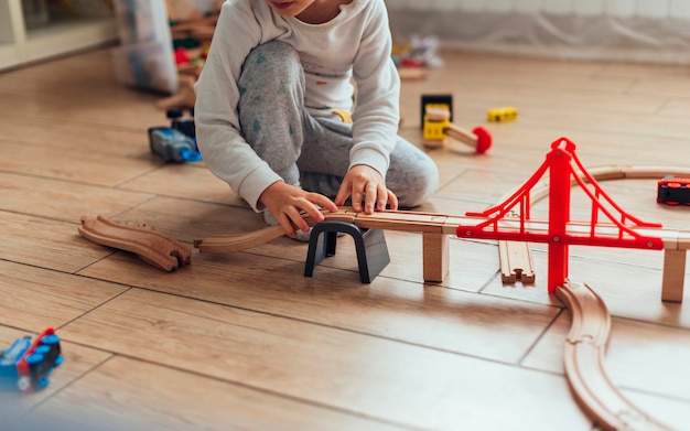 Free photo kid playing with toy train