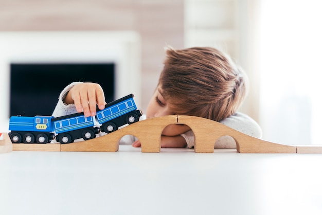 Free photo kid playing with toy train