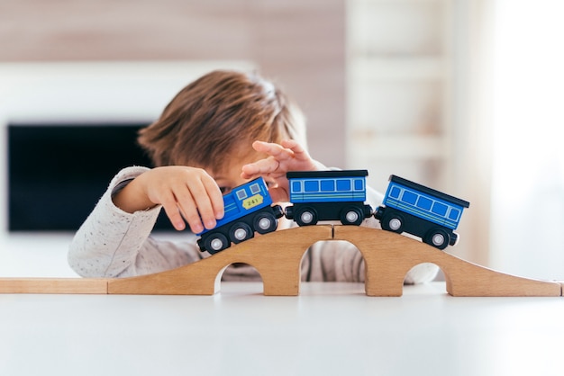 Free photo kid playing with toy train