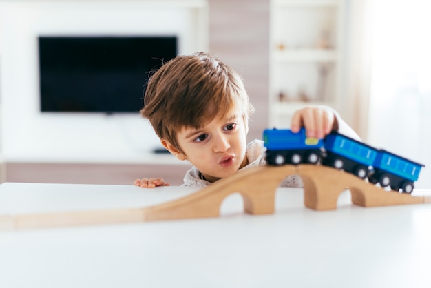 Free photo kid playing with toy train