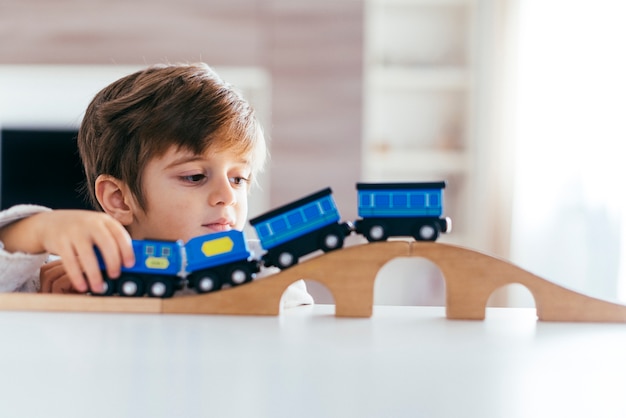 Free photo kid playing with toy train