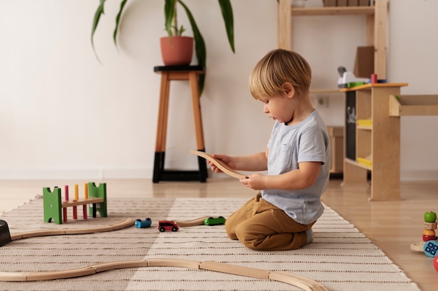 Kid playing with wooden toy full shot