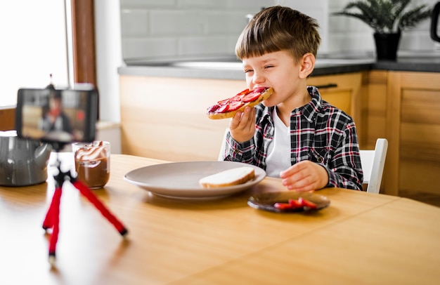 Kid recording himself while eating