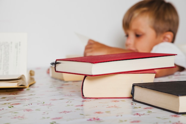 Kid sitting with books