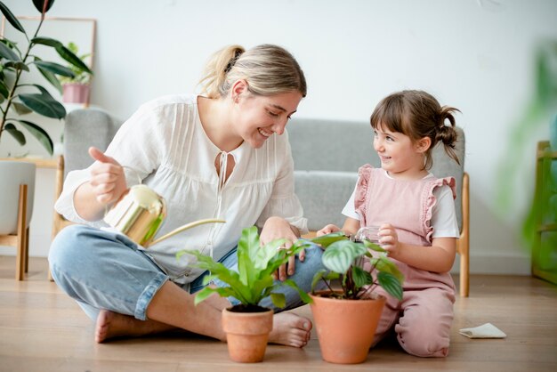 Kid watering potted plants at home