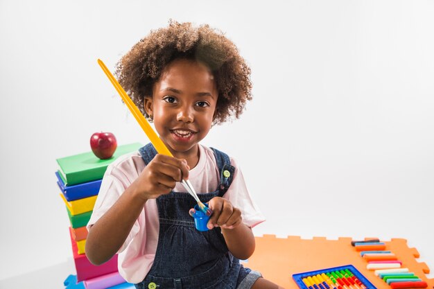 Kid with brush and paint in studio 