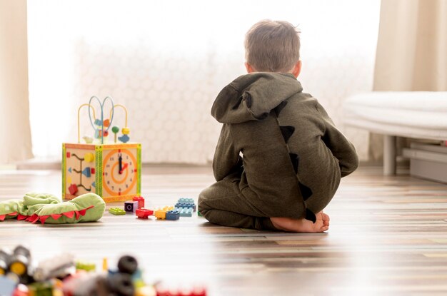 Kid with costume playing at home