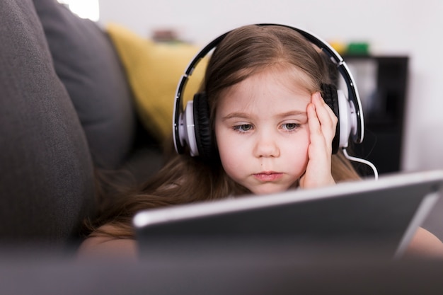 Kid with tablet on couch