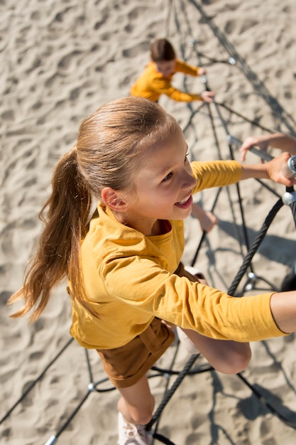 Kids climbing rope full shot