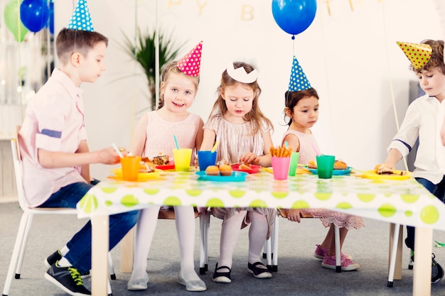 Free Photo kids in colored funny caps