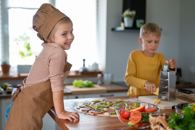 Free photo kids cooking and having fun at home