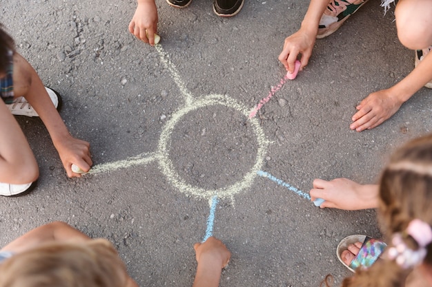 Free Photo kids drawing a sun with chalk