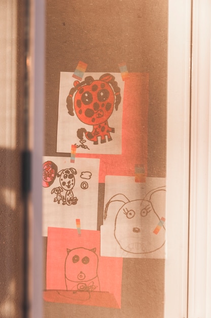 Free photo kids drawings behind window