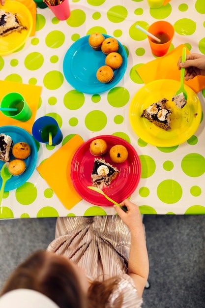 Free photo kids eating cakes from above