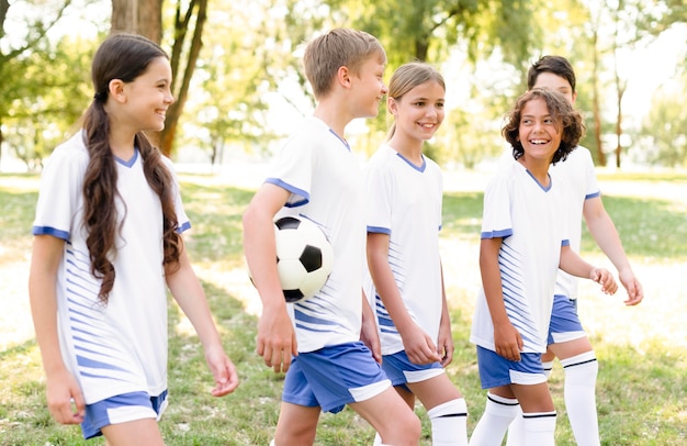 Kids in football equipment getting ready for a match