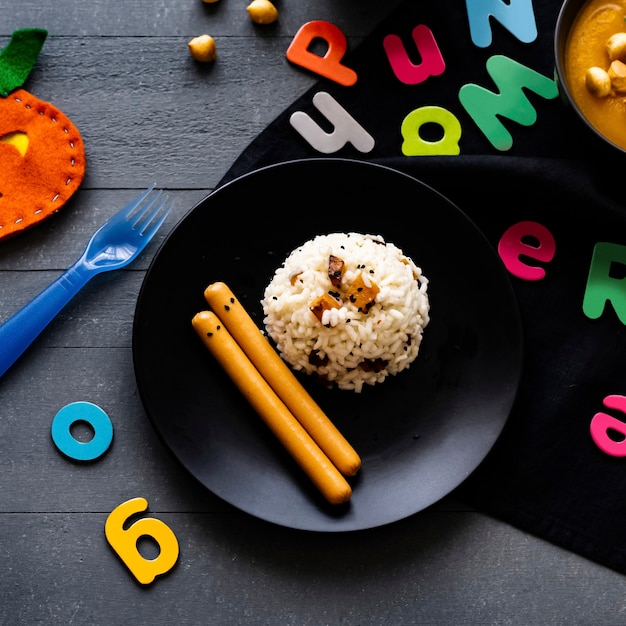 Free Photo kids halloween party food with pumpkin risotto and frankfurters