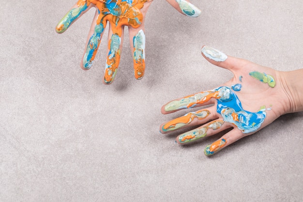 Free Photo kids hands with colorful acrylic oil mix