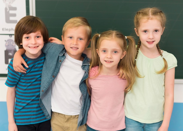 Kids holding each other in classroom