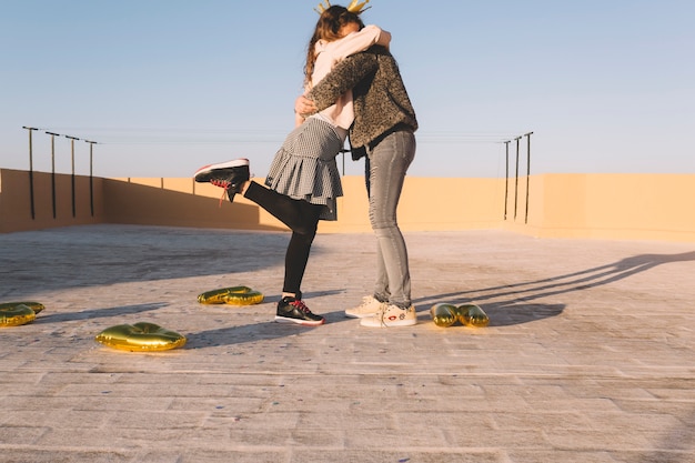 Free photo kids hugging on roof