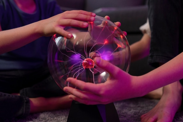 Free photo kids interacting with a plasma ball