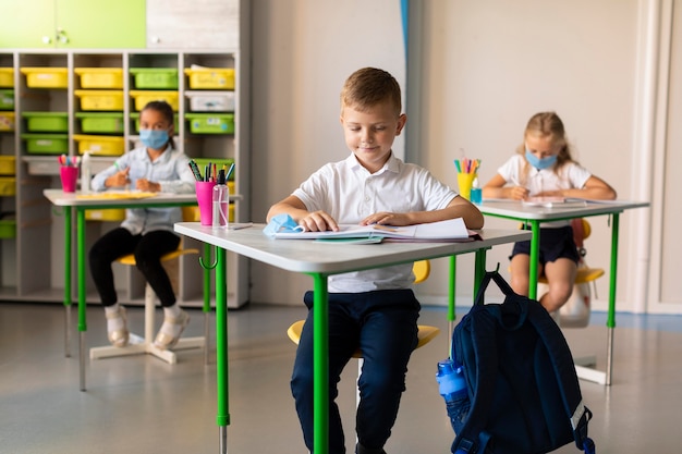 Kids keeping the social distance in classroom