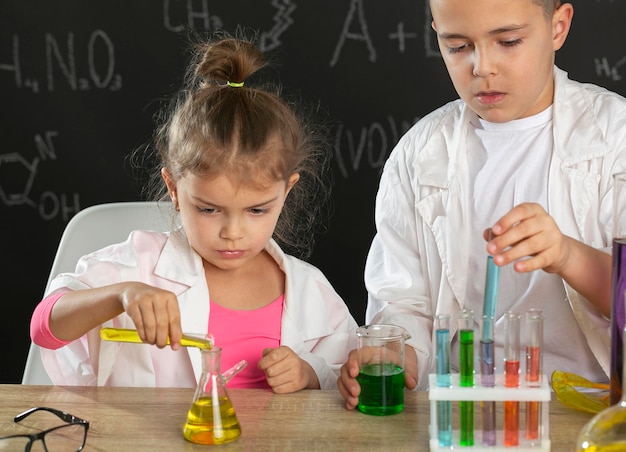 Free photo kids in laboratory doing experiments