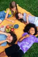 Free photo kids laying on cloth high angle