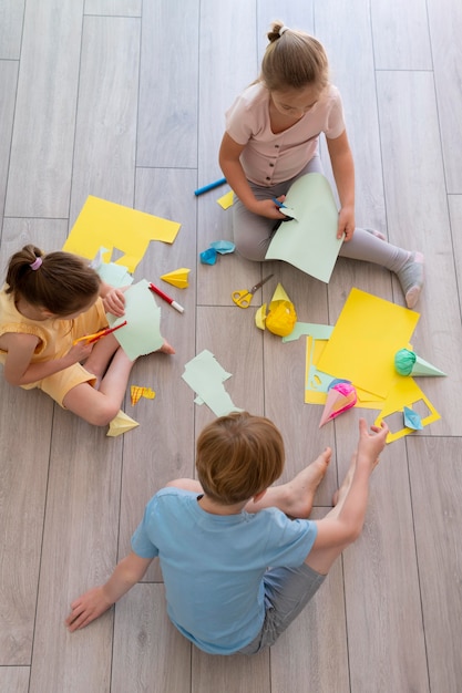 Kids playing with paper full shot