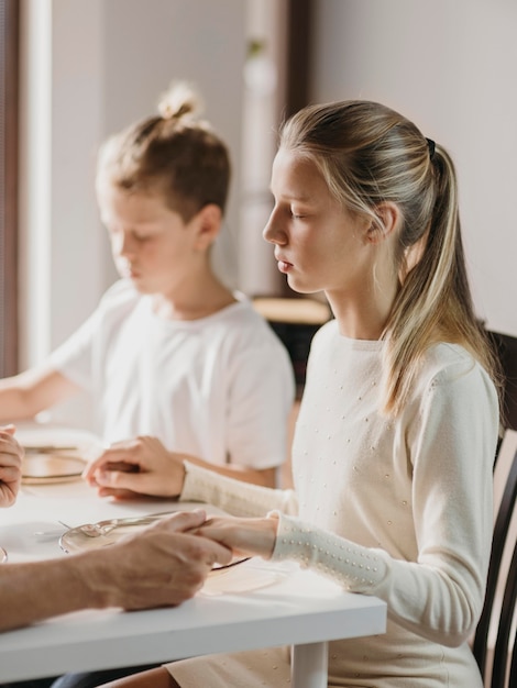 Kids praying before eating