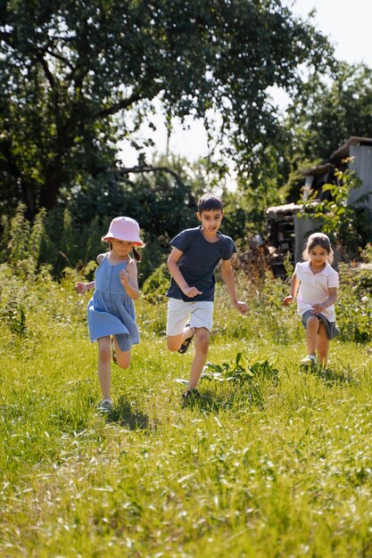 Kids running and playing in grass field outdoors