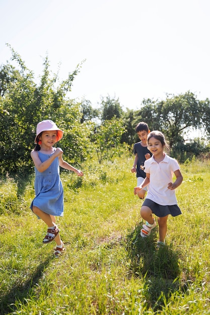 Kids running and playing in grass field outdoors