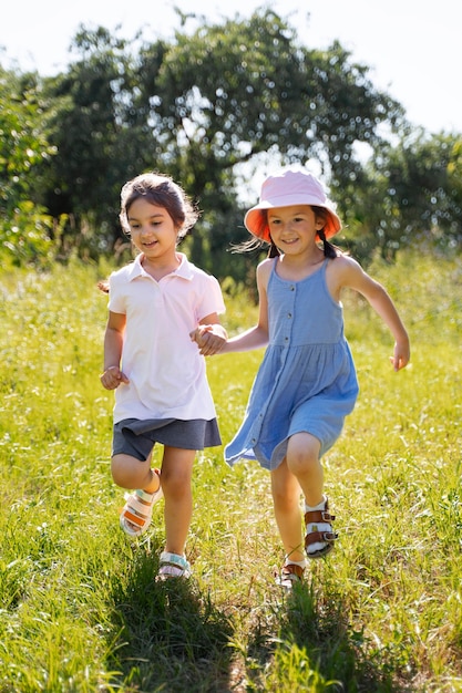 Kids running and playing in grass field outdoors