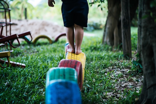  Kids running on tires in the playground.