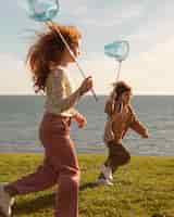 Free photo kids running with butterfly nets