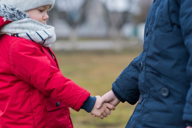 Kids shaking hands outside