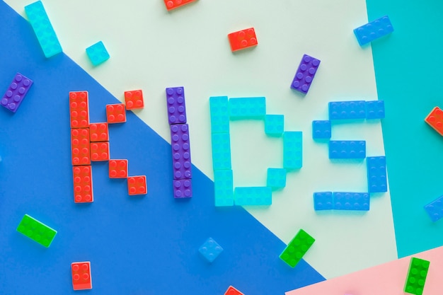 Free photo kids spelled word with plastic blocks background