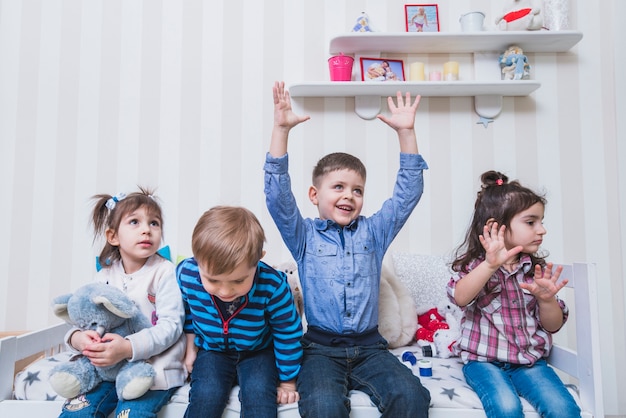 Free photo kids spending time together on bed