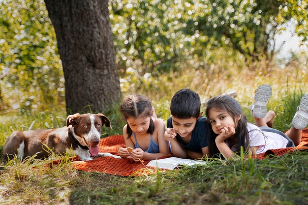 Kids spending time together outdoors on blanket enjoying childhood