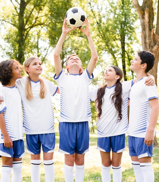 Kids in sportswear playing football