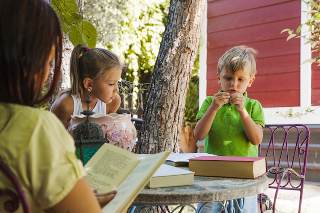 Free photo kids studying in garden