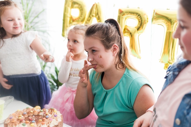 Free photo kids and teenager tasting cake