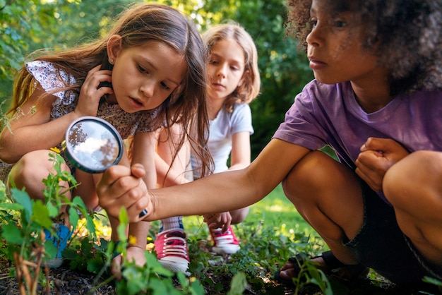 Free photo kids with magnifying glass full shot