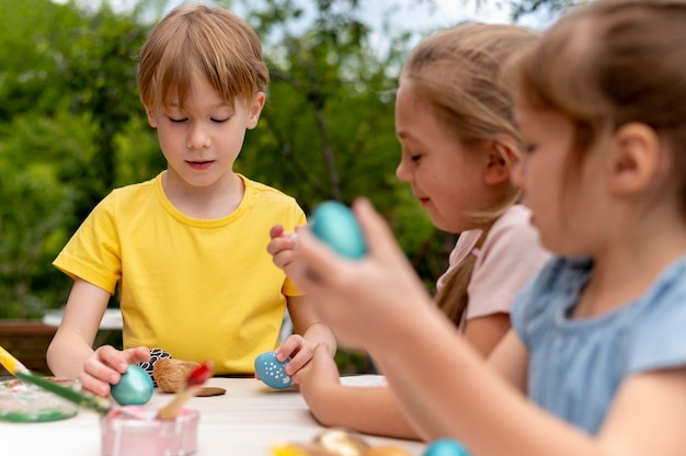 Free photo kids with painted eggs close up