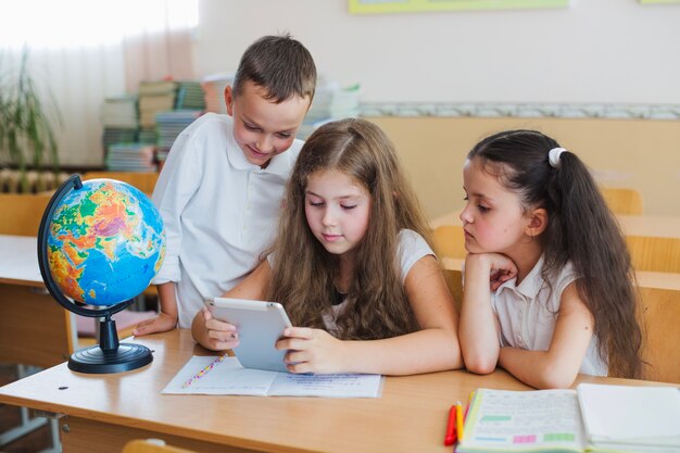 Kids with tablet at table