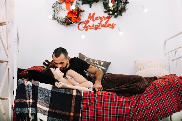 Kissing couple on bed