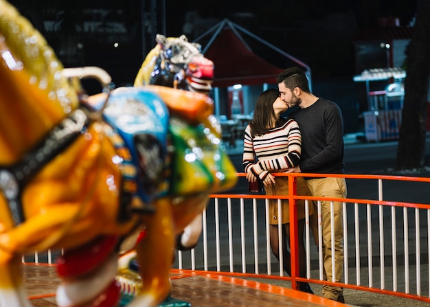 Kissing couple in a theme park