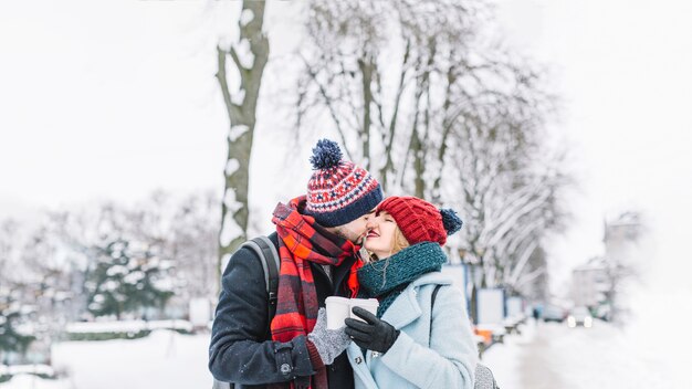 Kissing tender couple on street