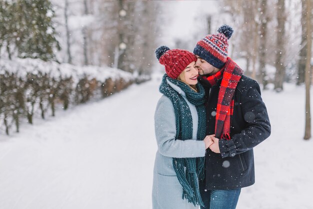 Kissing tender couple in winter time